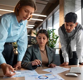 Digital marketing consultants analyzing business data and performance charts.