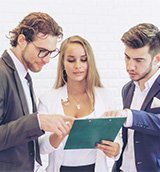 SME consulting team reviewing digital strategies on a tablet.